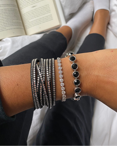 Woman wearing black and white bracelets