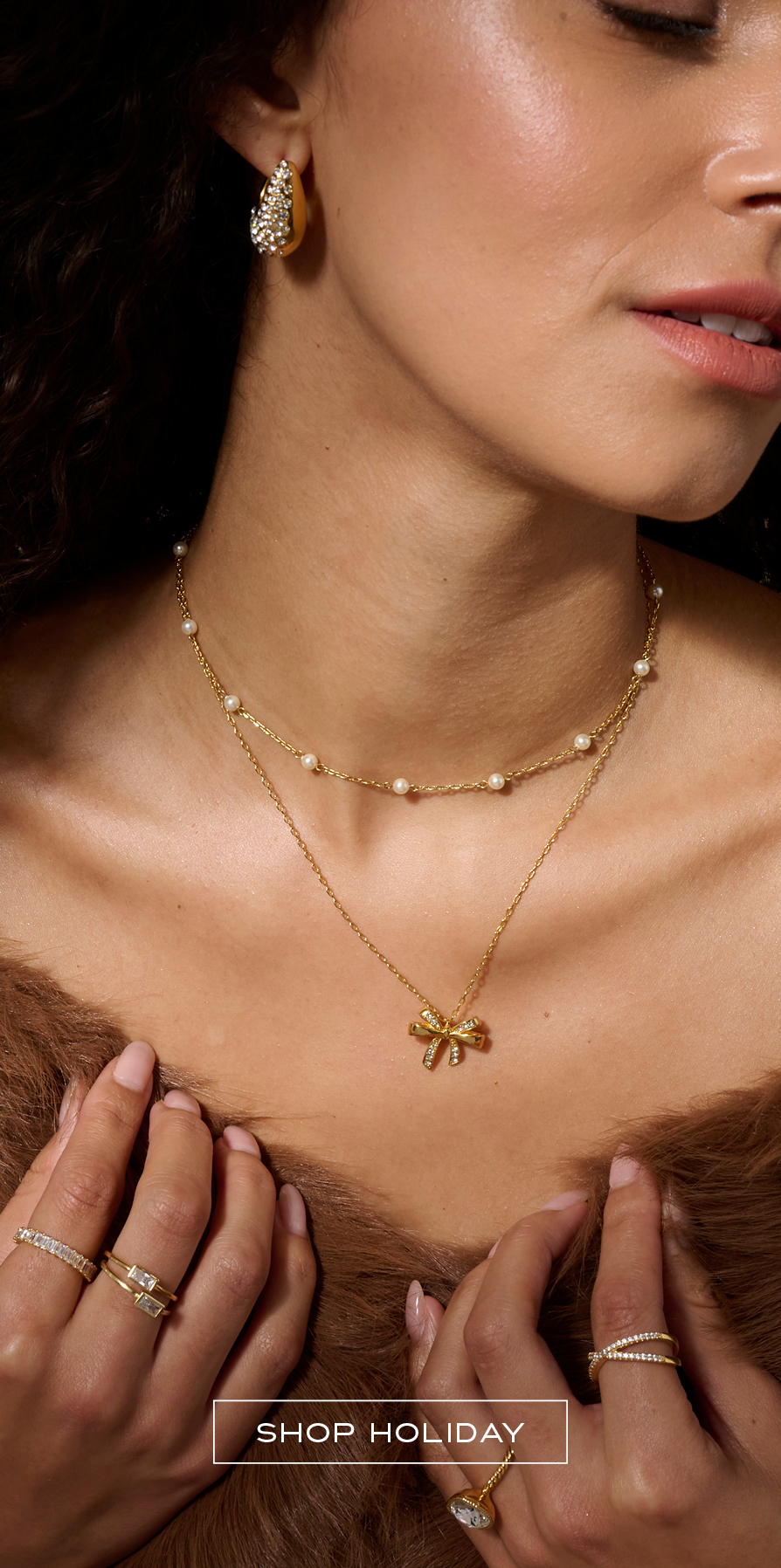 Woman wearing holiday inspired golden bow jewelry