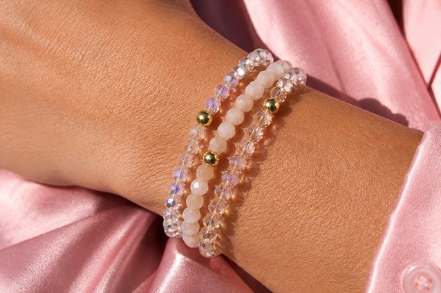 Debbie $10 Bracelet Set Woman wearing layered golden necklaces