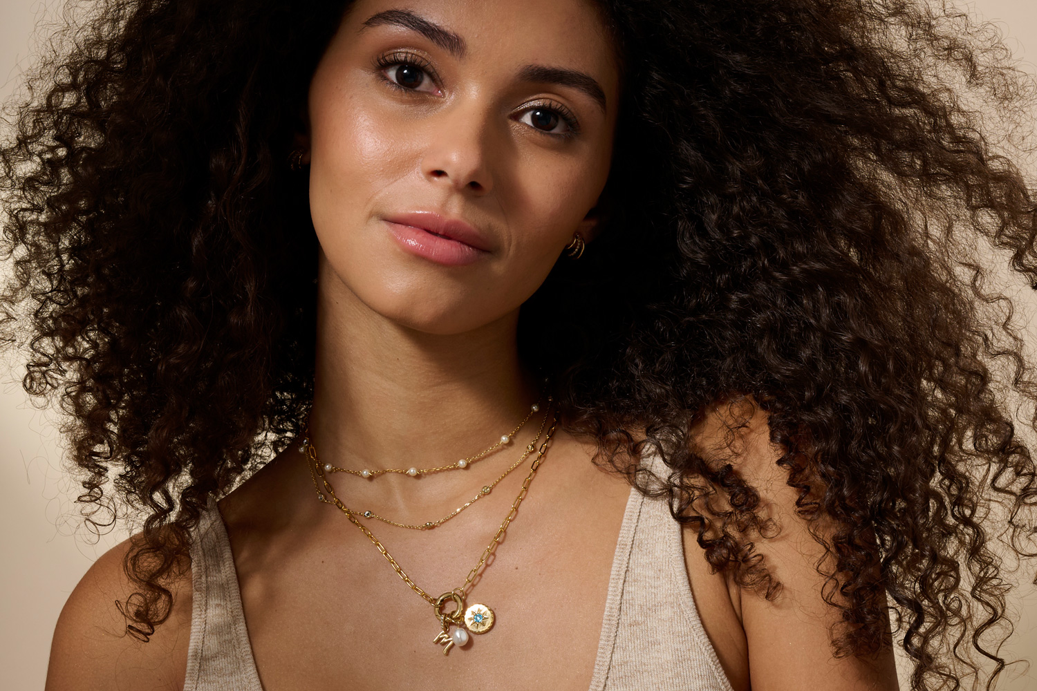 Woman wearing layered golden necklaces