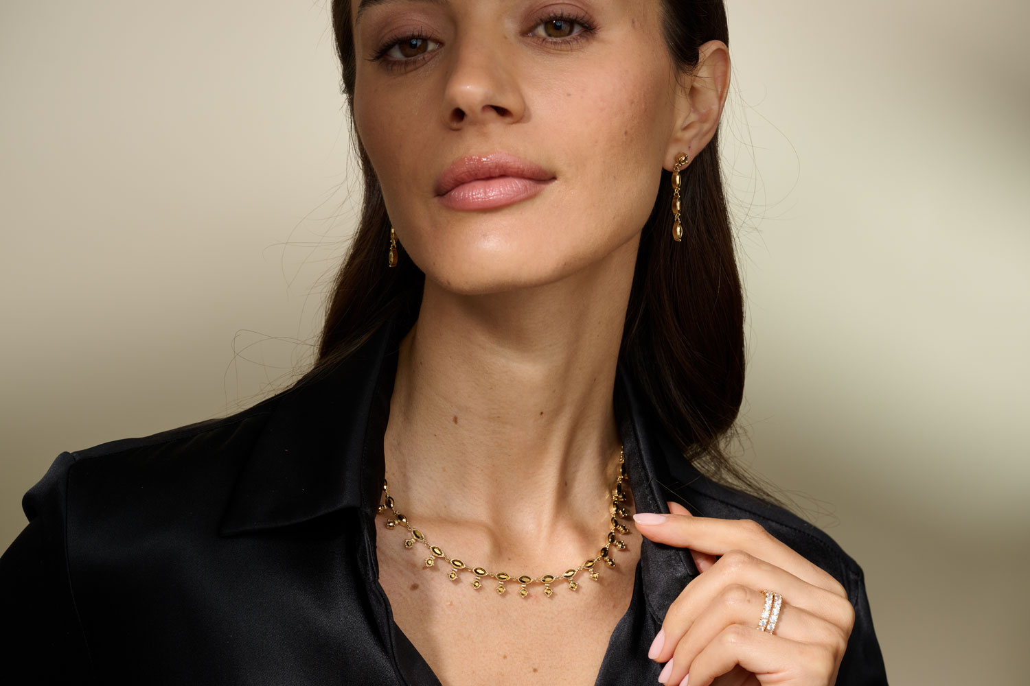 Woman wearing layered golden necklaces